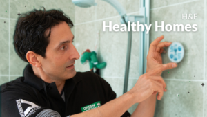 Tahir, a Green Doctor in London, fitting an energy saving measure in a shower