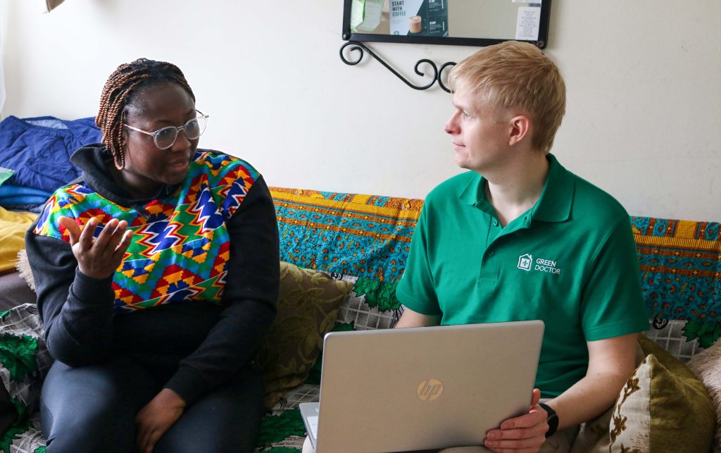 Daniel Brittle and Pearl (Green Doctors service user) speaking about energy bills with laptop